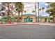 Community clubhouse features a covered entry, red accents, and beautiful desert landscaping in front at 1509 Linnbaker Ln # 203, Las Vegas, NV 89110