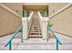 Exterior view of a staircase leading to a residential unit, with teal handrails at 1509 Linnbaker Ln # 203, Las Vegas, NV 89110