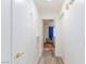 Bright hallway leading to the bedroom featuring neutral walls and wood-look flooring at 1509 Linnbaker Ln # 203, Las Vegas, NV 89110