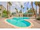 Community pool area has a uniquely shaped pool with surrounding tall palm trees and desert landscaping at 1509 Linnbaker Ln # 203, Las Vegas, NV 89110