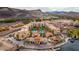 Beautiful aerial view of lakeside property featuring pools, colorful buildings, and mountain views at 17 Grand Corniche Dr, Henderson, NV 89011