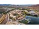 An aerial photograph of luxurious lakeside apartments with pools, docks, and mountain views in a serene community at 17 Grand Corniche Dr, Henderson, NV 89011