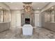 Luxurious bathroom with a soaking tub, dual vanities, and custom tiled fireplace feature at 17 Grand Corniche Dr, Henderson, NV 89011
