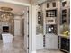 Bathroom with custom cabinetry, lighting, and a free-standing soaking tub near an electric fireplace at 17 Grand Corniche Dr, Henderson, NV 89011