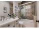Elegant bathroom showcases a shower-tub combination with decorative tile surround, vanity, and decorative art at 17 Grand Corniche Dr, Henderson, NV 89011