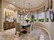 Elegant dining room with chandelier lighting, mountain views, and stylish decor at 17 Grand Corniche Dr, Henderson, NV 89011