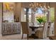 Formal dining area with elegant chandeliers and picturesque mountain views at 17 Grand Corniche Dr, Henderson, NV 89011