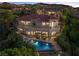 Elegant two-story home with a red tile roof, balcony, pool, and lush landscaping at 17 Grand Corniche Dr, Henderson, NV 89011