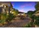 Exterior view of a luxury home with a courtyard featuring lush landscaping and a charming water fountain at 17 Grand Corniche Dr, Henderson, NV 89011