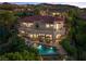 Elegant two-story home with a red tile roof, balcony, pool, and lush landscaping at 17 Grand Corniche Dr, Henderson, NV 89011
