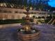 Multi-tiered water fountain illuminated at night, nestled in a meticulously landscaped garden at 17 Grand Corniche Dr, Henderson, NV 89011