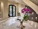Welcoming foyer featuring a decorative table, tiled floors, wine storage, and a modern chandelier at 17 Grand Corniche Dr, Henderson, NV 89011