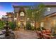 Beautiful home featuring a water fountain, elegant double doors, and lush landscaping at 17 Grand Corniche Dr, Henderson, NV 89011