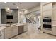 Bright kitchen boasts custom cabinets, stone counters, stainless appliances, and elegant lighting fixtures at 17 Grand Corniche Dr, Henderson, NV 89011