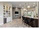 Modern kitchen and bar area with stone accent wall and sleek countertops at 17 Grand Corniche Dr, Henderson, NV 89011