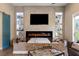 Elegant living room with a modern fireplace, TV, and built-in display shelves at 17 Grand Corniche Dr, Henderson, NV 89011