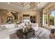 Elegant living room with spiral staircase, stylish decor, and an abundance of natural light at 17 Grand Corniche Dr, Henderson, NV 89011