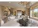 Elegant living room with spiral staircase, stylish decor, and an abundance of natural light at 17 Grand Corniche Dr, Henderson, NV 89011