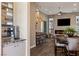 Open-concept living room featuring a fireplace, modern furniture, and sleek bar seating at 17 Grand Corniche Dr, Henderson, NV 89011