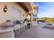 Outdoor kitchen with stainless steel appliances and barbecue, perfect for entertaining by the pool at 17 Grand Corniche Dr, Henderson, NV 89011