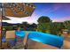 Inviting backyard pool with a beautiful sunset view and relaxing patio seating at 17 Grand Corniche Dr, Henderson, NV 89011