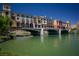 Picturesque waterfront property featuring colorful buildings and a scenic bridge at 17 Grand Corniche Dr, Henderson, NV 89011