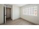 Bright bedroom featuring wood-look floors and a large window for natural light at 1800 Edmond St # 115, Las Vegas, NV 89146