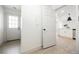 Bright entryway featuring a white door with glass panes and light wood-look flooring, leading to an open kitchen at 1800 Edmond St # 115, Las Vegas, NV 89146