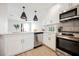 Bright kitchen features stainless steel appliances, white cabinets, and pendant lighting at 1800 Edmond St # 115, Las Vegas, NV 89146