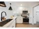 Well-lit kitchen features stainless steel appliances, white cabinets, and sleek black fixtures at 1800 Edmond St # 115, Las Vegas, NV 89146