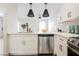 Kitchen boasts white cabinets, stainless steel appliances, quartz countertops, and pendant lighting at 1800 Edmond St # 115, Las Vegas, NV 89146