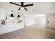 Open-concept living room and kitchen boasts modern lighting and wood-look flooring at 1800 Edmond St # 115, Las Vegas, NV 89146