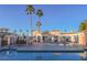Community pool area with lounge chairs and palm trees at 1800 Edmond St # 115, Las Vegas, NV 89146