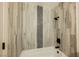 Tile shower with gray-wood-look tile and black hardware at 1800 Edmond St # 115, Las Vegas, NV 89146