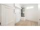 Utility room featuring wood-look floors, white cabinets, and tank water heater at 1800 Edmond St # 115, Las Vegas, NV 89146