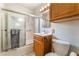 The cozy bathroom features a shower with glass doors and a wooden vanity with a towel ring at 1904 Fontenelle St, Las Vegas, NV 89102