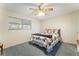 This is a carpeted bedroom with a window and a bed with decorative pillows and quilt at 1904 Fontenelle St, Las Vegas, NV 89102