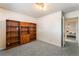 A carpeted bedroom featuring a built-in wooden bookcase and an adjacent bedroom visible through the open door at 1904 Fontenelle St, Las Vegas, NV 89102