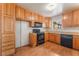 Bright kitchen with wooden cabinets, modern black appliances, and laminate flooring at 1904 Fontenelle St, Las Vegas, NV 89102