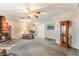 Open living room with brick fireplace, plush carpet, and natural light at 1904 Fontenelle St, Las Vegas, NV 89102