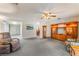 Spacious living area with plush carpet, built-in shelving, and comfortable recliner at 1904 Fontenelle St, Las Vegas, NV 89102
