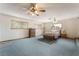 Spacious main bedroom with carpet flooring and bright windows, complemented by two ceiling fans at 1904 Fontenelle St, Las Vegas, NV 89102