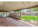 The covered patio offers views of the backyard and features a brick floor and privacy from the neighbors at 1904 Fontenelle St, Las Vegas, NV 89102
