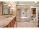 Elegant bathroom featuring double sinks, granite counters, and a soaking tub at 20 Via Mantova # 306, Henderson, NV 89011