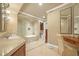 Luxurious bathroom with double vanity, soaking tub, and glass shower at 20 Via Mantova # 306, Henderson, NV 89011