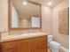 Elegant bathroom featuring a decorative framed mirror, tile countertop, and neutral color palette at 20 Via Mantova # 306, Henderson, NV 89011