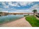 Beautiful lakeside homes feature a sandy beach and boat docks beneath a partly cloudy sky at 20 Via Mantova # 306, Henderson, NV 89011