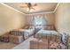 Bedroom with twin beds, ceiling fan, plush carpet, and window views at 20 Via Mantova # 306, Henderson, NV 89011