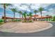 Circular driveway with palm trees and covered walkway to the main building at 20 Via Mantova # 306, Henderson, NV 89011
