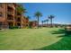 Well-maintained green space adjacent to building, accented by palm trees and desert landscaping at 20 Via Mantova # 306, Henderson, NV 89011